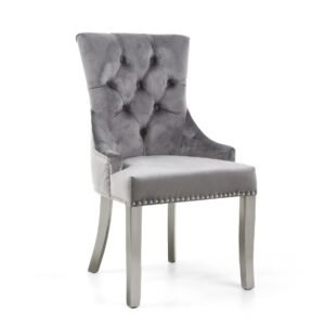 Elegant gray velvet chair with high button-tufted back, smooth seat, and silver nailhead trim. Tone is sophisticated and modern.