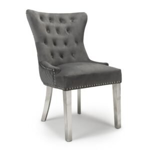 Elegant gray velvet chair with a high back, button tufting, and silver nailhead trim. It has silver legs, exuding a luxurious, modern feel.