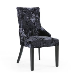 Elegant dining chair with a high back and plush, dark blue velvet fabric. The smooth, curved design and dark wooden legs convey a sophisticated and inviting tone.