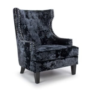 Elegant dark gray velvet armchair with a high back and studded detailing along the edges. The plush texture conveys a luxurious, modern feel.