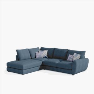 Blue L-shaped sectional sofa with three back cushions and two patterned throw pillows. The sofa is set against a plain white background.