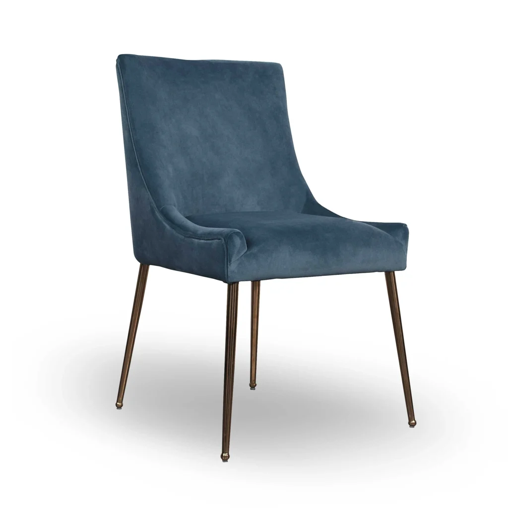 A modern, sleek blue velvet chair with a slightly curved backrest and thin metal legs, exuding a minimalist and elegant design.