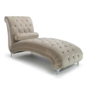 Luxurious beige chaise lounge with tufted velvet upholstery, silver studded accents, and curved lines. Elegantly modern design evokes comfort and style.